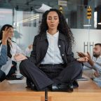 calm-businesswoman-professional-taking-break-meditating-sitting-table-office-meeting-ignoring
