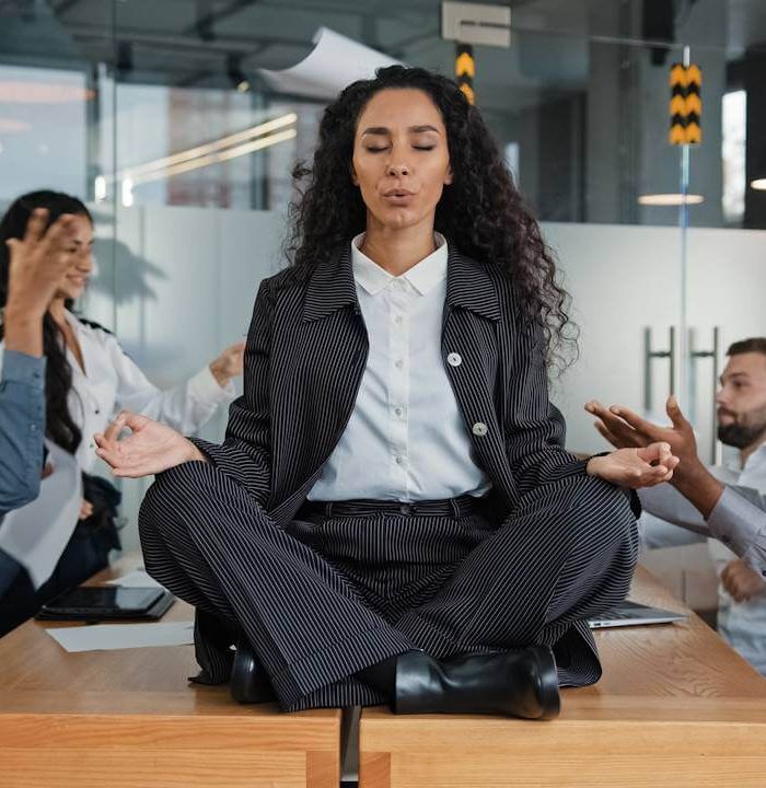 calm-businesswoman-professional-taking-break-meditating-sitting-table-office-meeting-ignoring